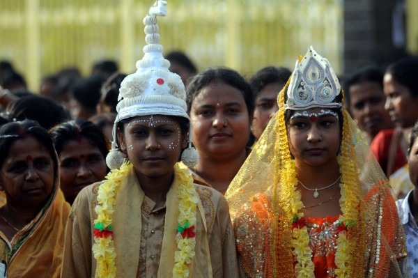 Agartala, India. 7th March 2012 -- Women dressed as bride and groom during a rally. -- Indian women take out a rally organised by Social welfare department to mark International Women's Day on the eve at India's northeastern capital of Agartala. International Women's Day is celebrated across the world on 8th March 2012.