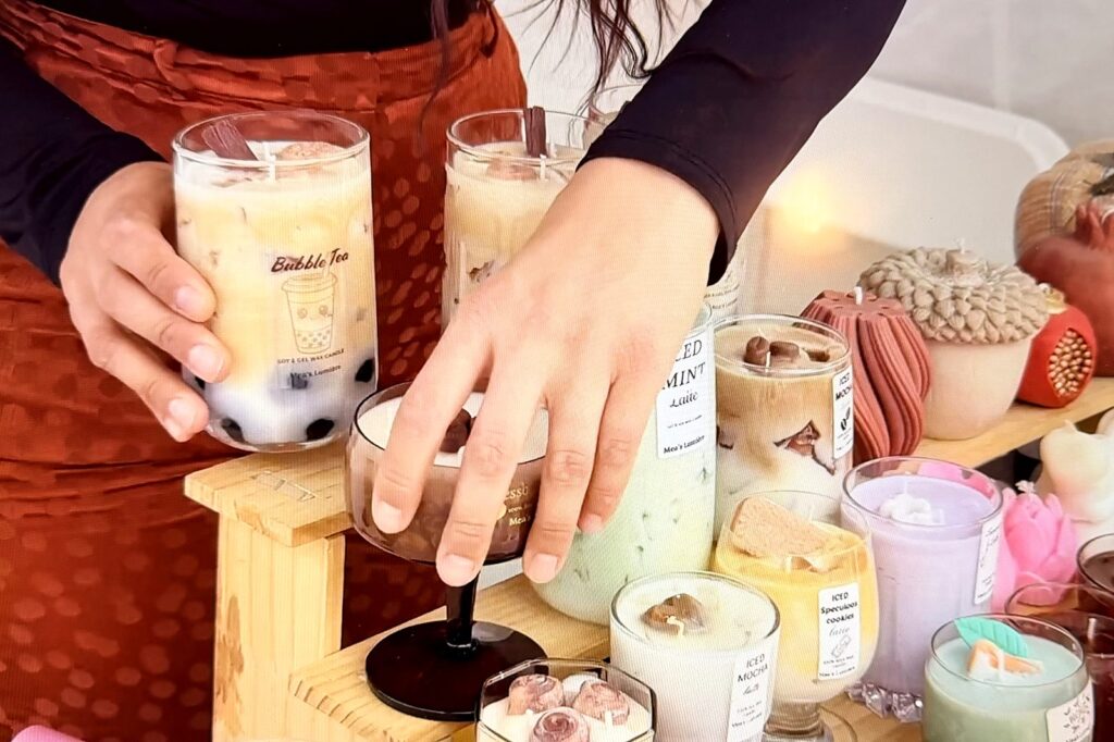 Sveće od repičinog voska: priča Subotičanke Anese Distel 2 Ruke slažu mirisne sveće u obliku bubble tea i ledene kafe na drvenoj polici